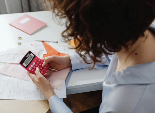 Woman Holding a Pink Calculator